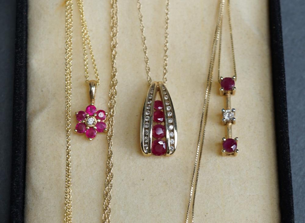 THREE 14 KARAT YELLOW GOLD RUBY 31798d