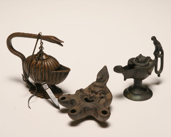Three archaic style oil lamps;