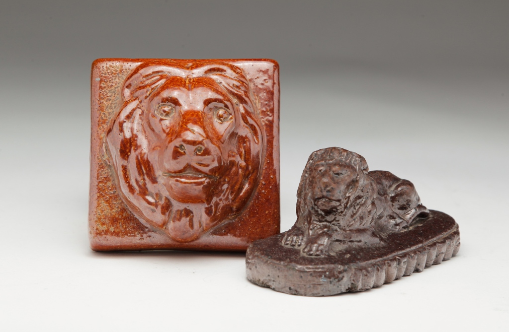 TWO OHIO SEWERTILE LION PAPERWEIGHTS.