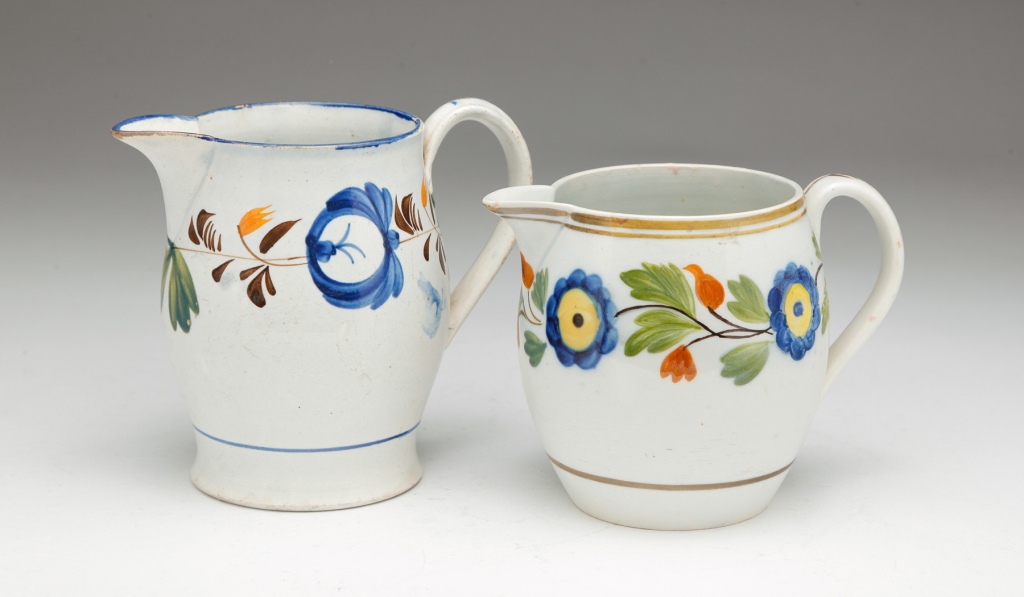 TWO ENGLISH PEARLWARE CREAM PITCHERS.