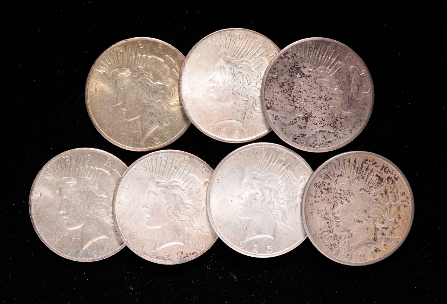 SEVEN SILVER PEACE DOLLARS. Includes