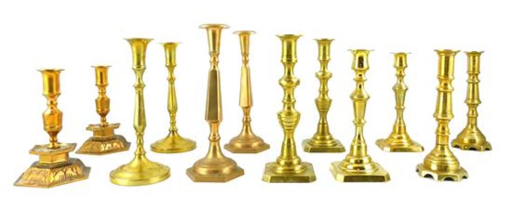 SIX PAIRS OF BRASS CANDLESTICKS,