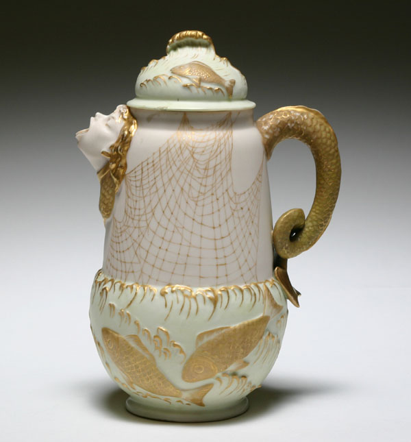 Belleek pitcher with raised fish pattern,