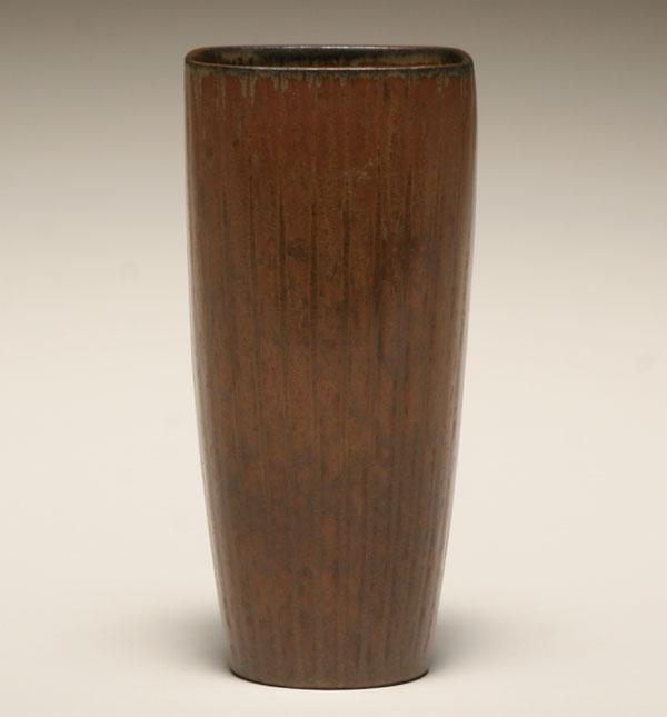 A ribbed vase in a brown glaze