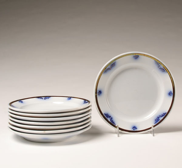 Eight ironstone plates with flow