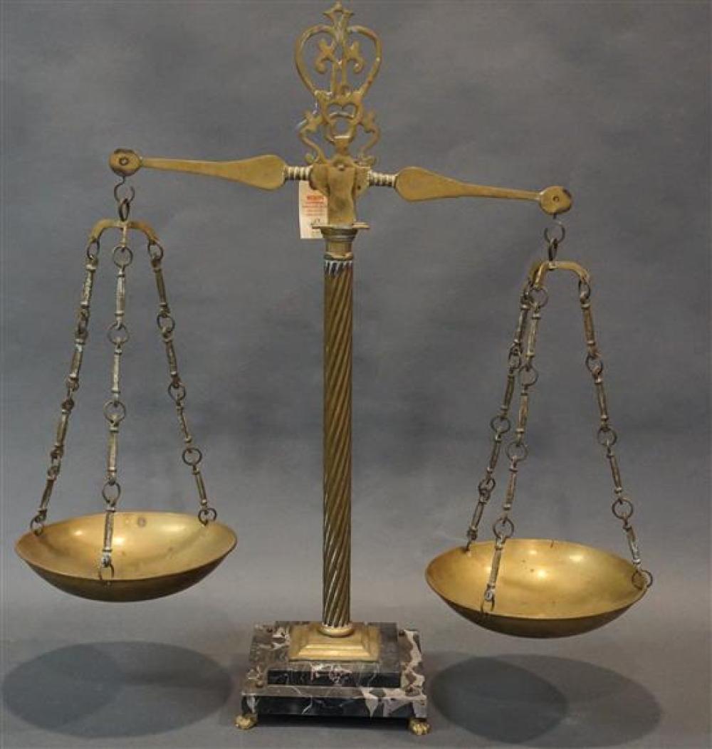 BRASS JUSTICE SCALE ON BLACK MARBLE