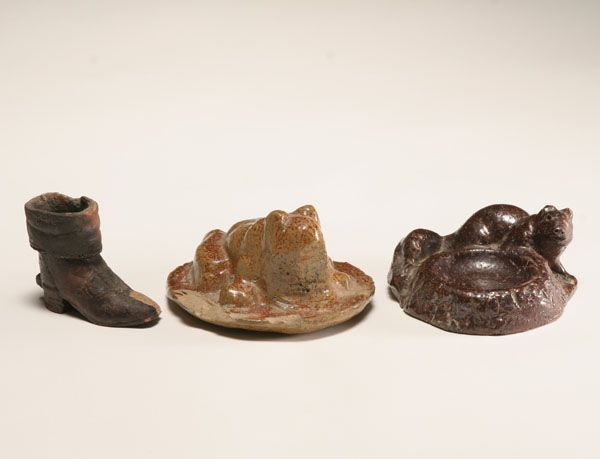 Three figural sewer tile pieces;