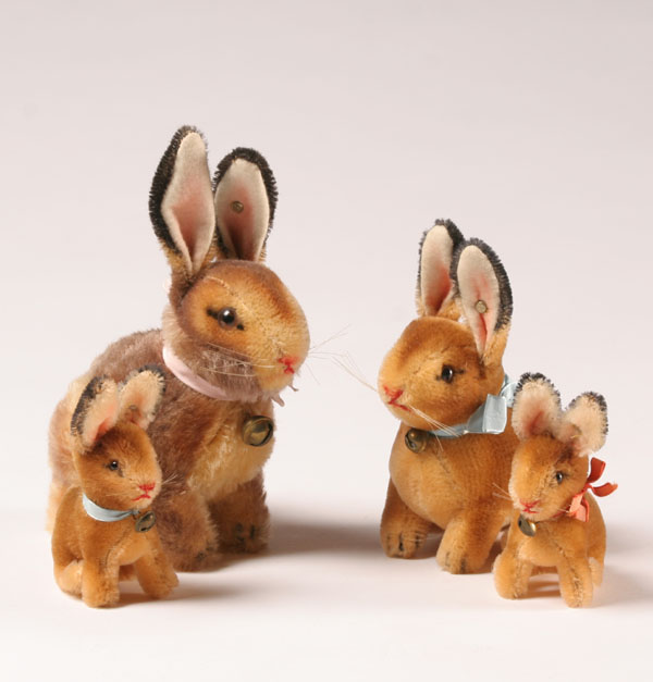Four Steiff bunnies all with ear buttons