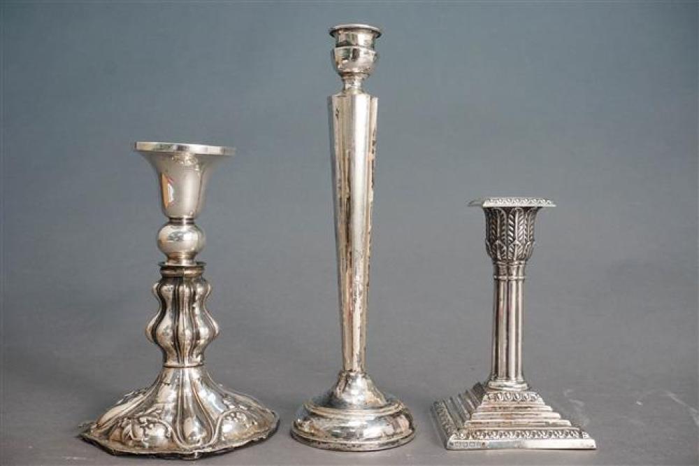 THREE WEIGHTED SILVER CANDLESTICKSThree