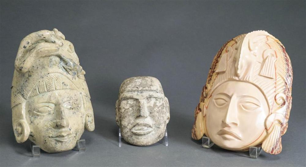 THREE CARVED STONE MASKSThree Carved 326ad5