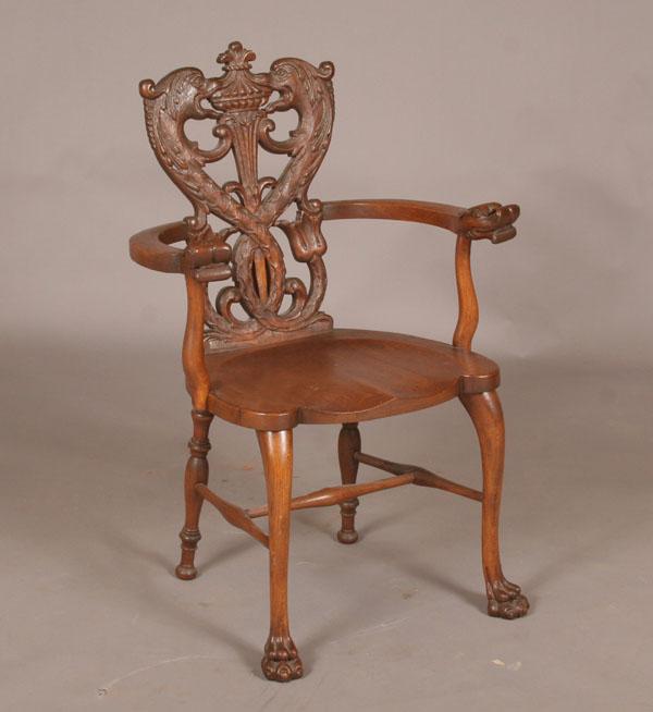 Ornately carved oak arm chair  50ac7