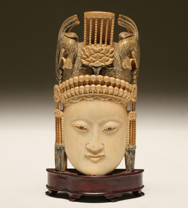 Carved ivory tusk of a Buddha head;