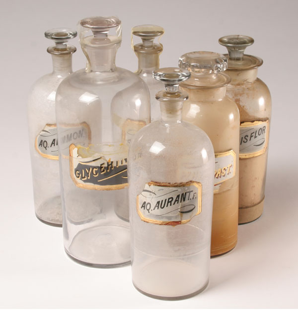 Six stoppered pharmacy bottles