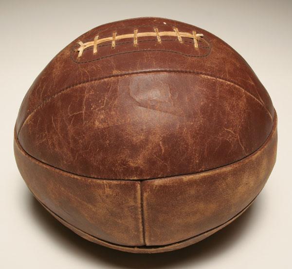 Leather medicine ball with rawhide stiching.