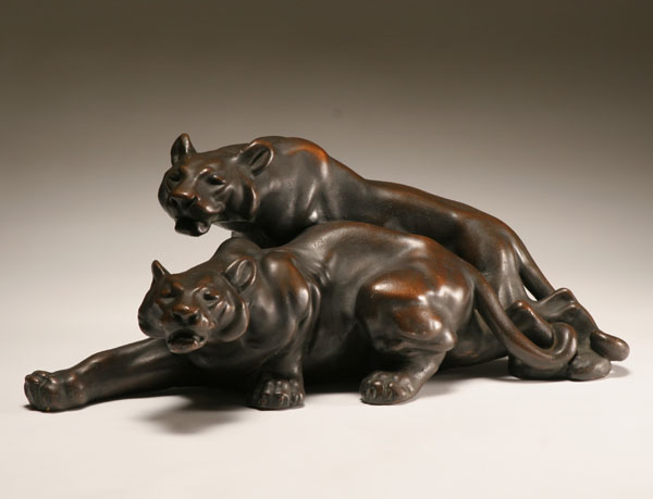 Two snarling bronze clad panthers group.