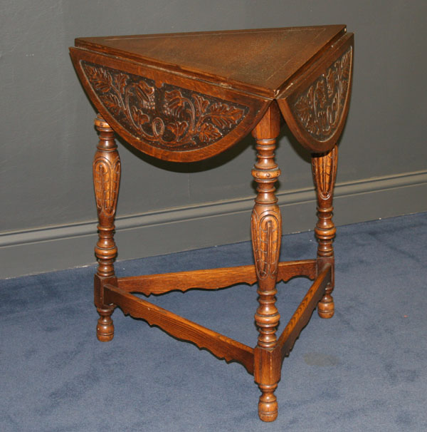 Tri-fold carved table; floral motif.