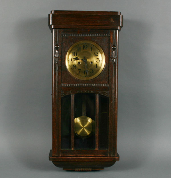 Oak wall clock with carved case, brass