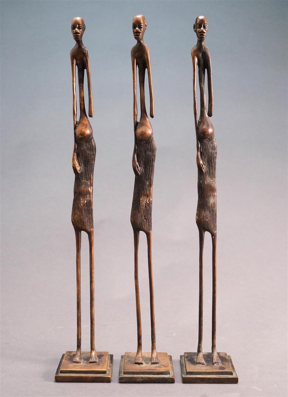 THREE AFRICAN PATINATED METAL STANDING