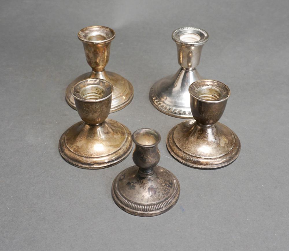 FIVE WEIGHTED STERLING SILVER CANDLESTICKS,