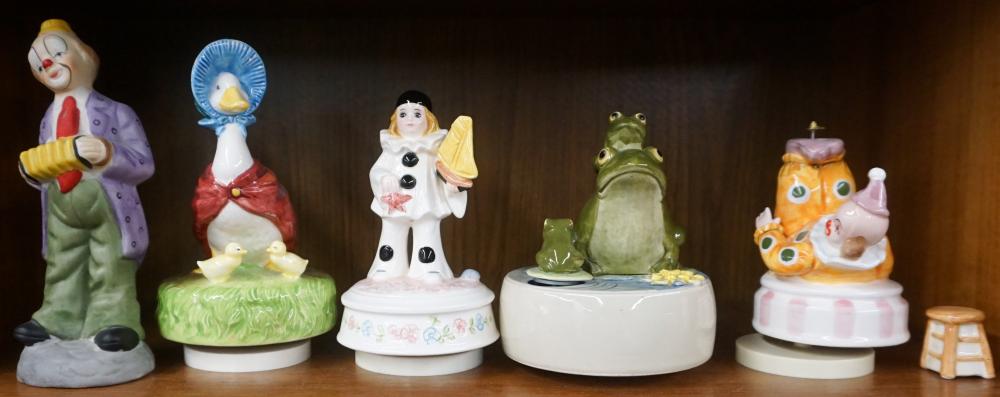 FOUR PORCELAIN MUSICAL FIGURINES AND