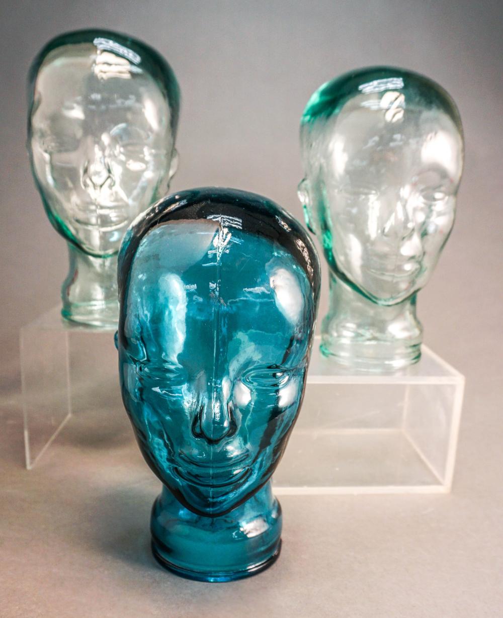 THREE MOLDED GLASS FIGURES OF HEADS 32af24