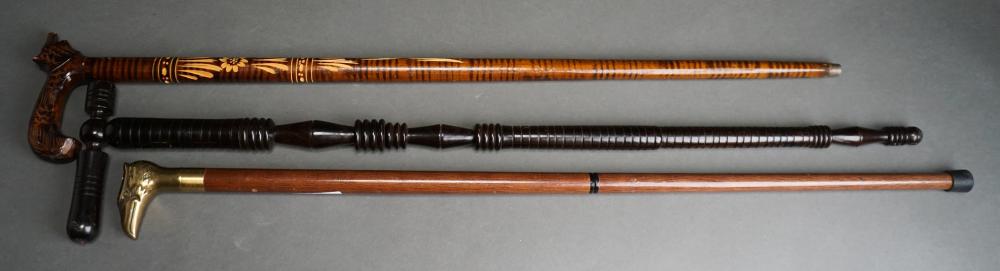 THREE CARVED WOOD WALKING STICKS CANESThree 32ec8a