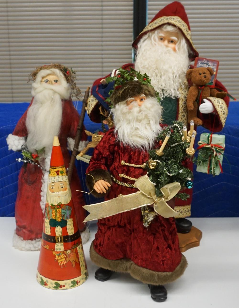 GROUP OF FOUR FIGURES OF SANTA