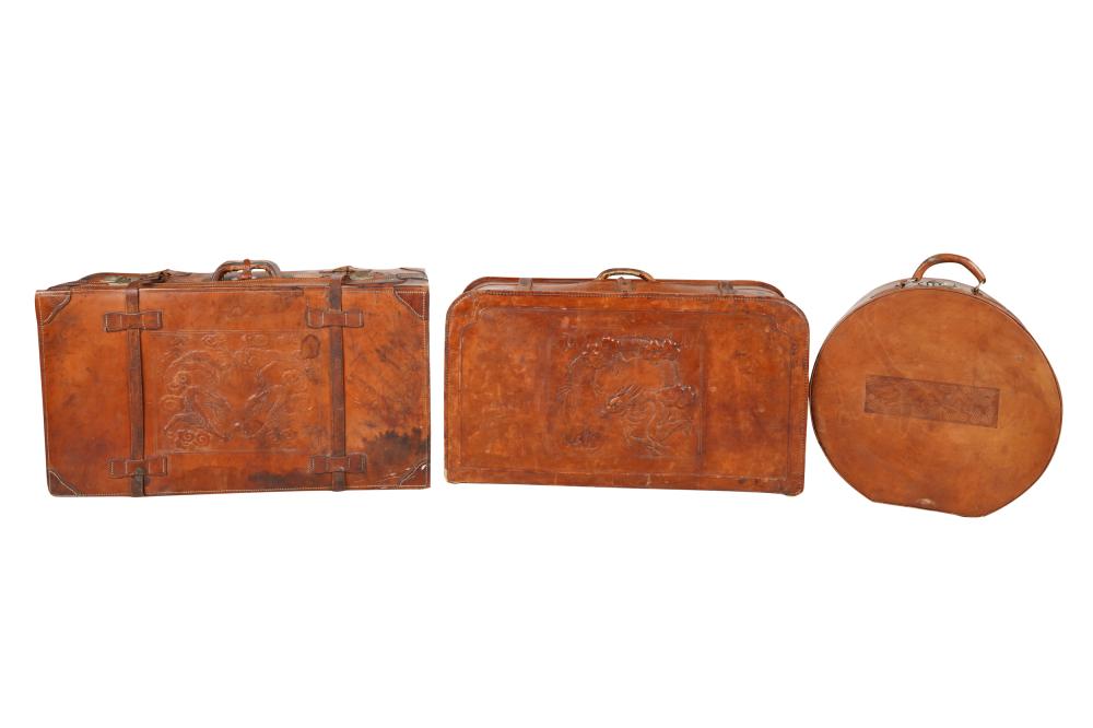 THREE LEATHER EMBOSSED SUITCASEScomprising