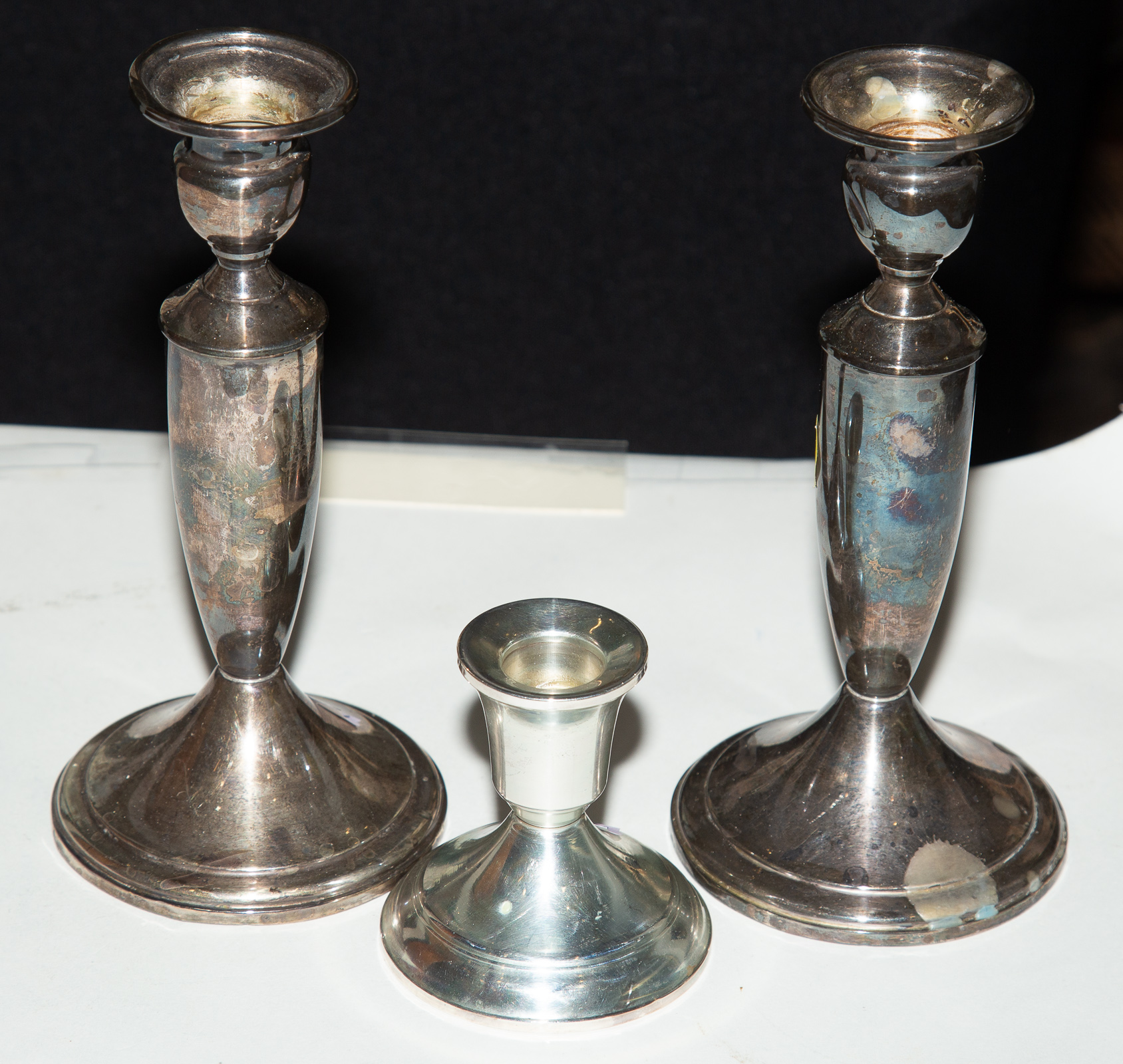 THREE STERLING WEIGHTED CANDLESTICKS
