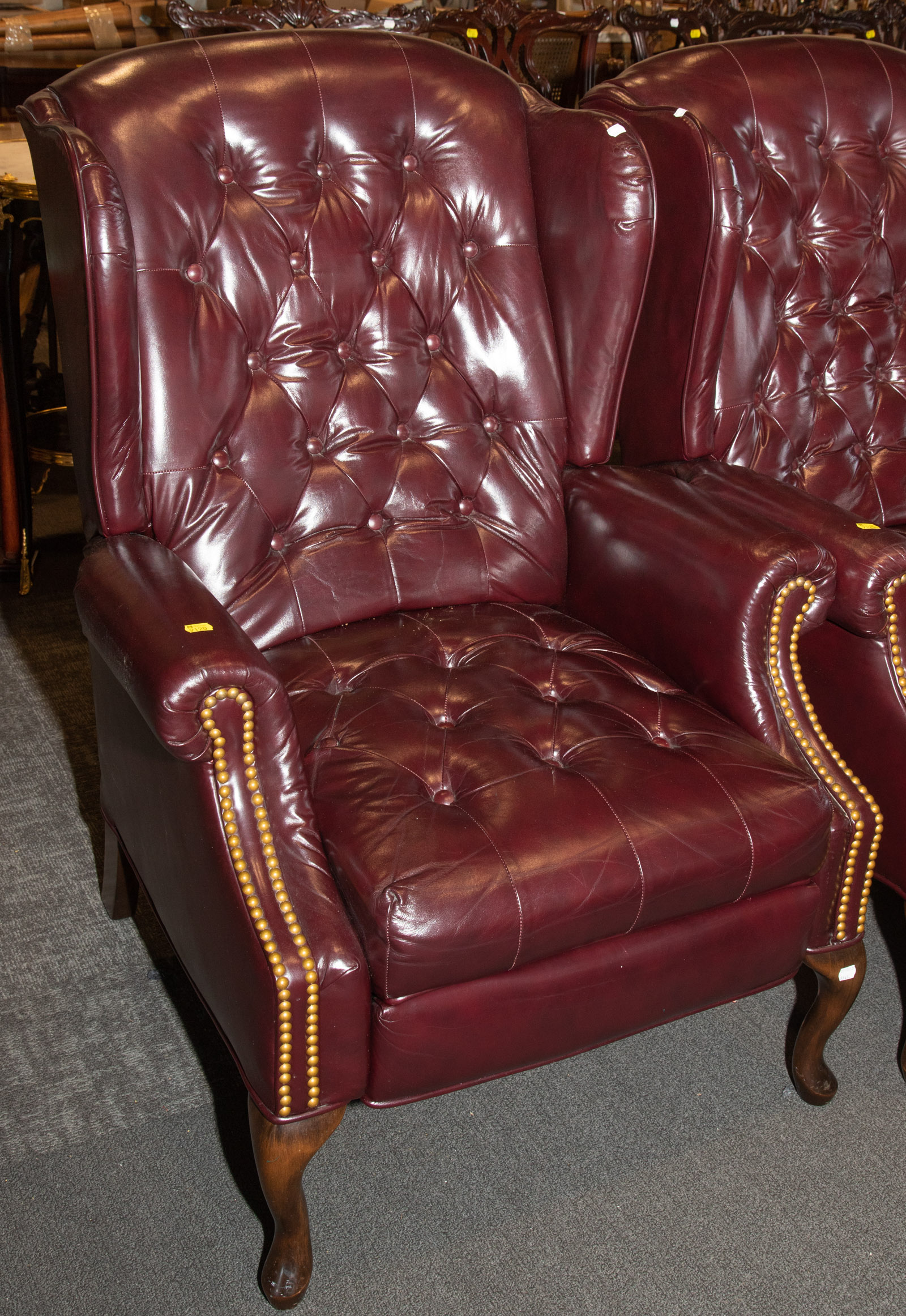 A MAROON LEATHER RECLINING WING