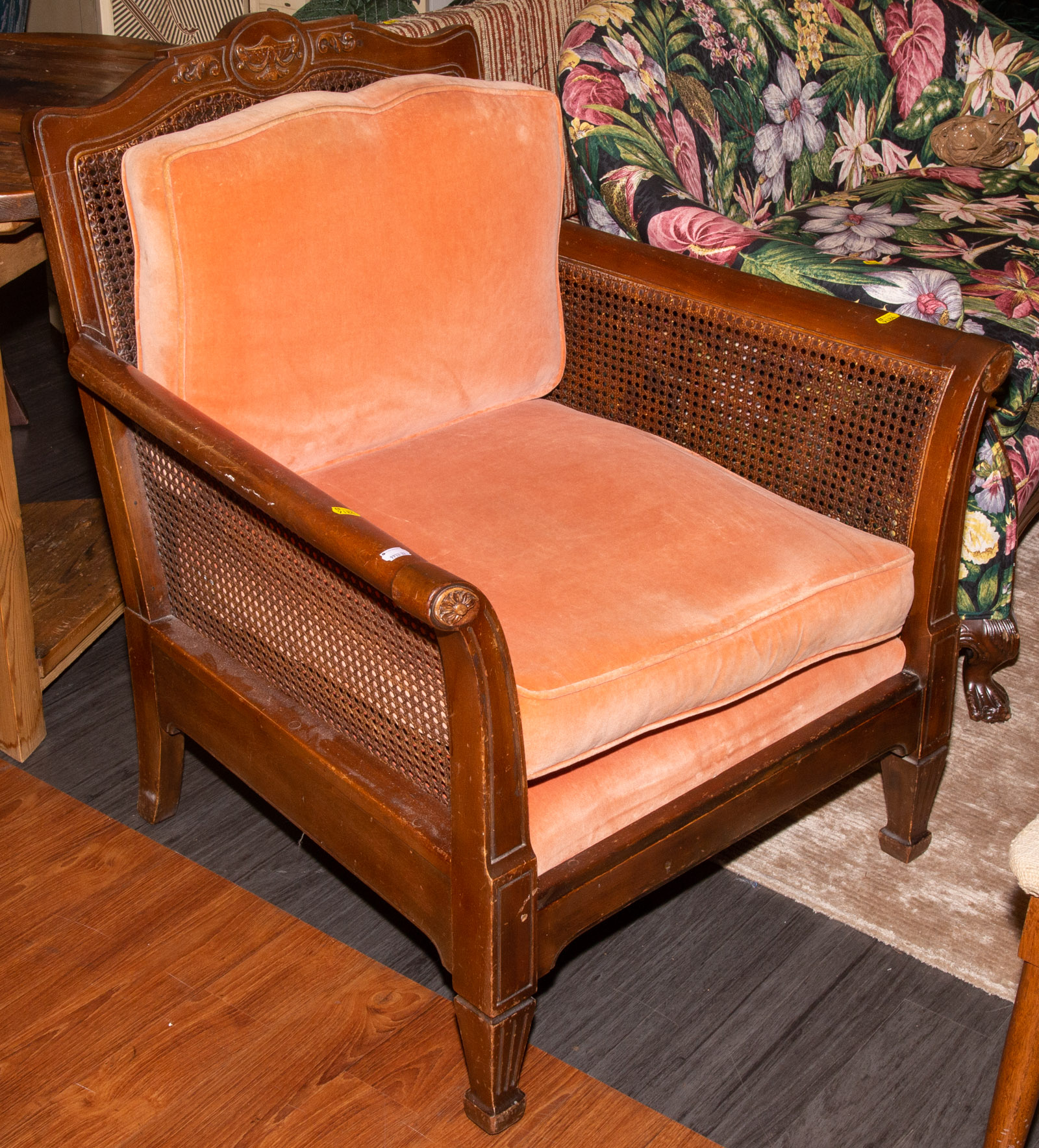 A CANED ARM CHAIR .