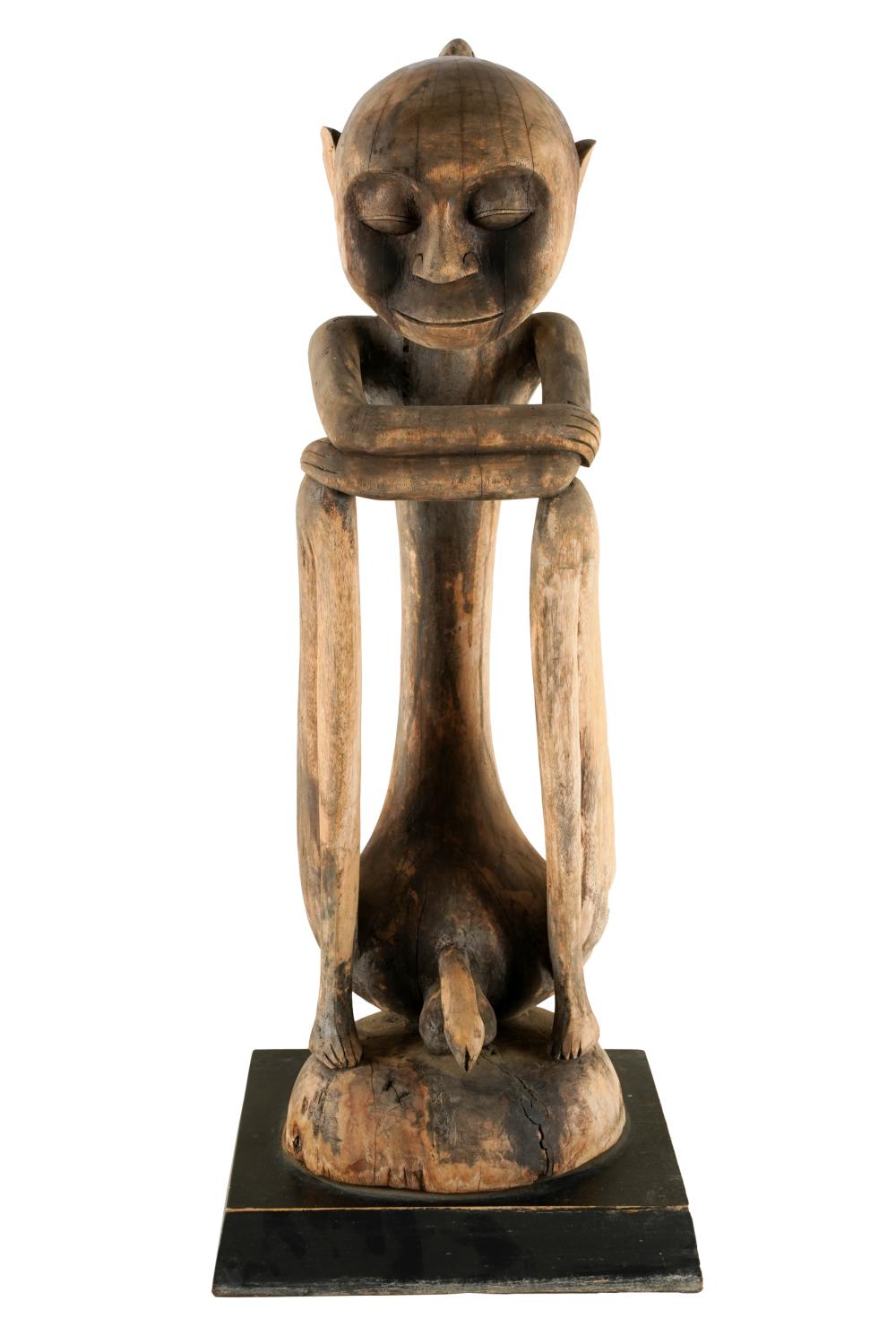 CARVED WOOD FIGURE OF A SEATED