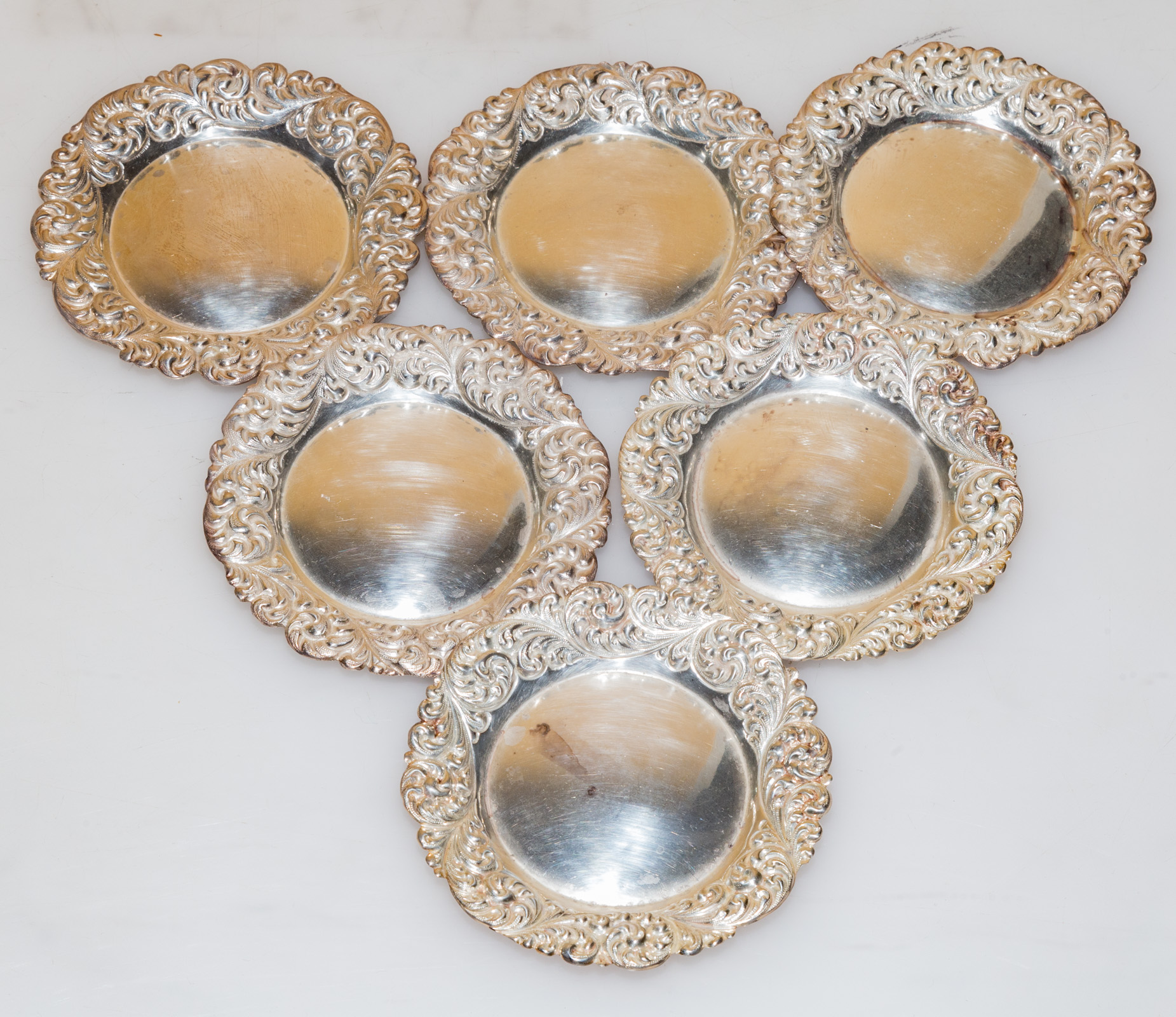 SIX STERLING REPOUSSE BORDER NUT DISHES