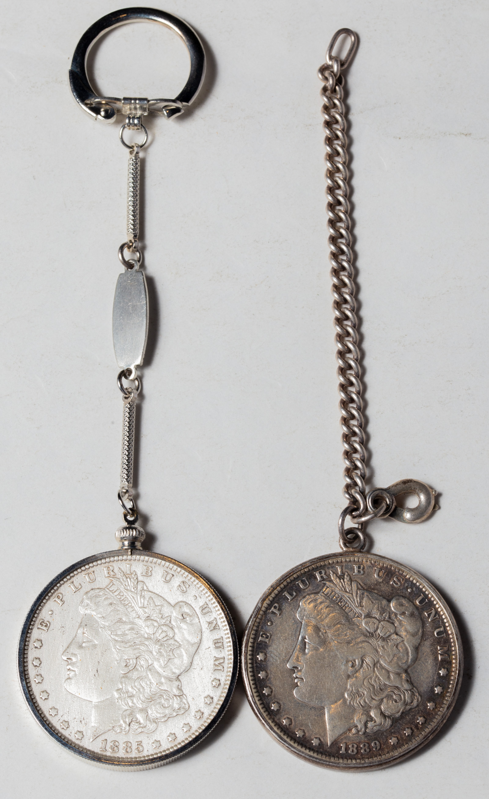 TWO MORGAN SILVER DOLLARS IN BEZELS 3345c8