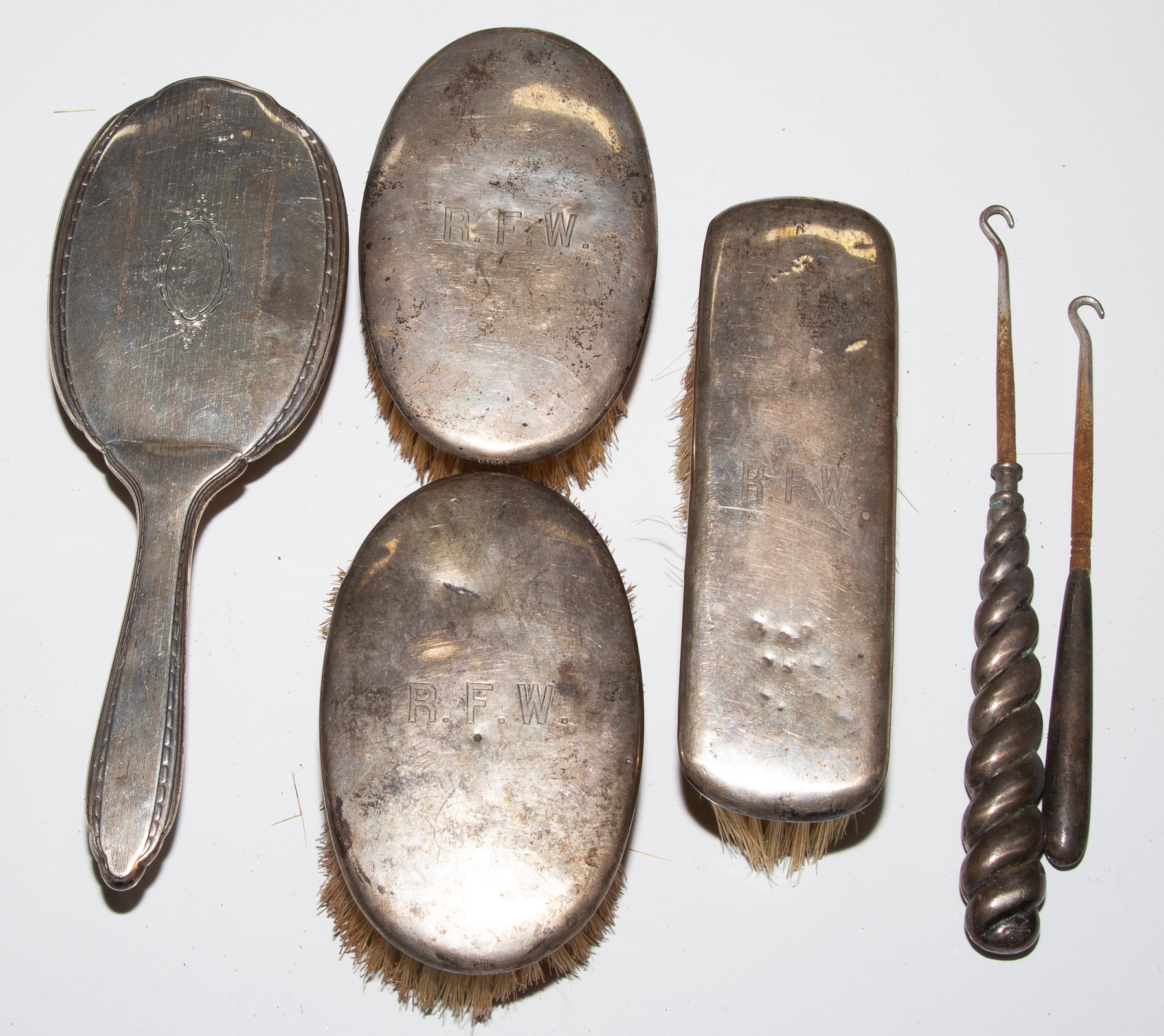 FOUR STERLING-MOUNTED DRESSER BRUSHES
