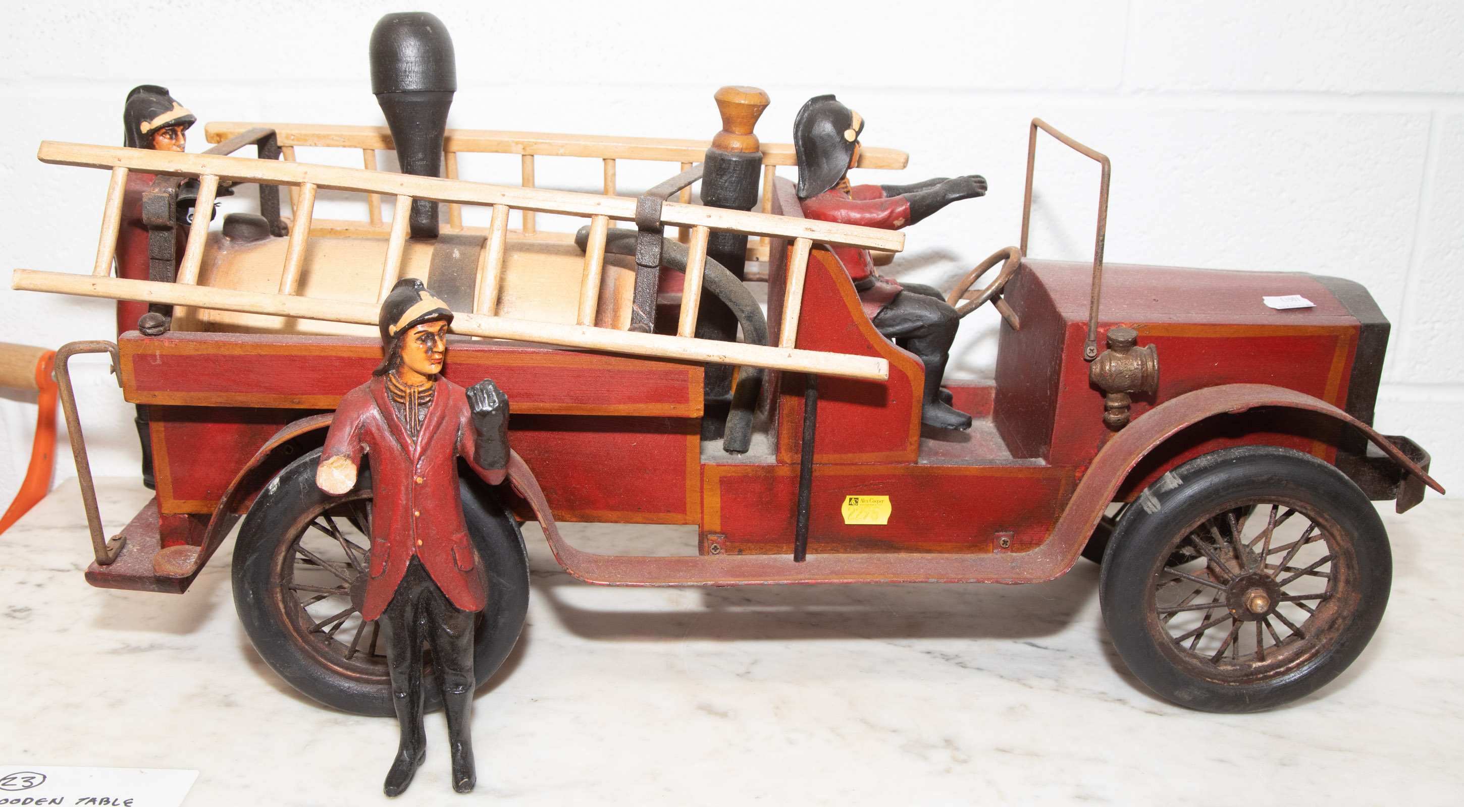 A FOLK ART STYLE WOOD FIRE TRUCK