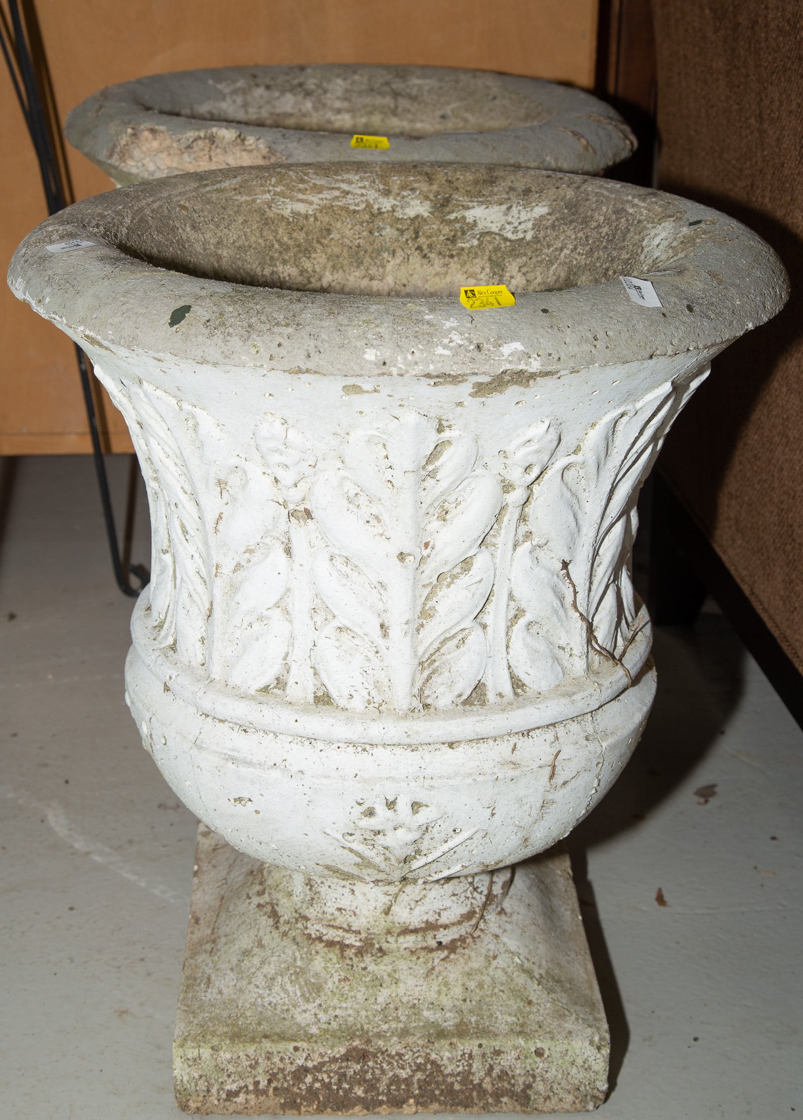 TWO CONCRETE GARDEN URNS Approximately