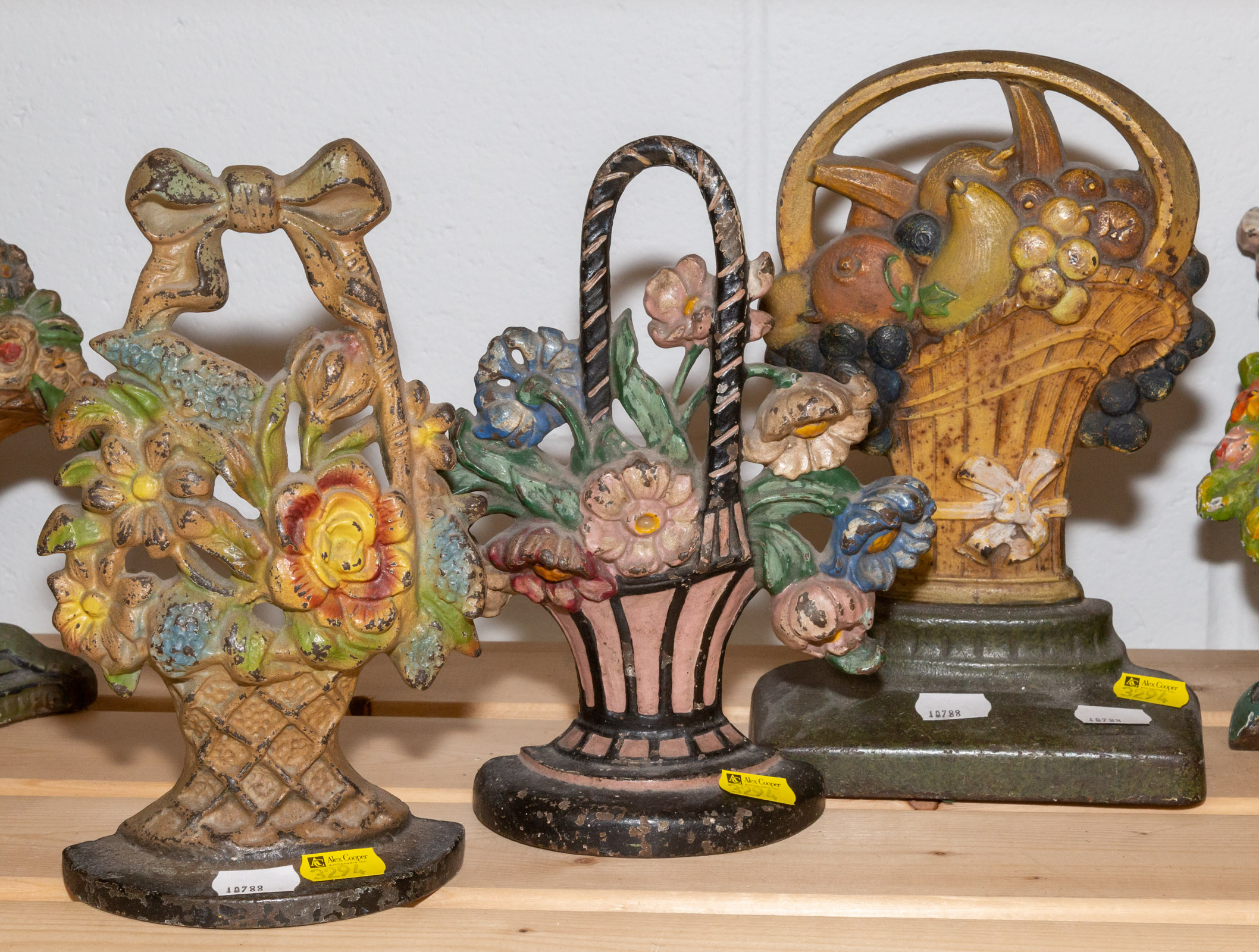 THREE FLORAL CAST IRON DOOR STOPS