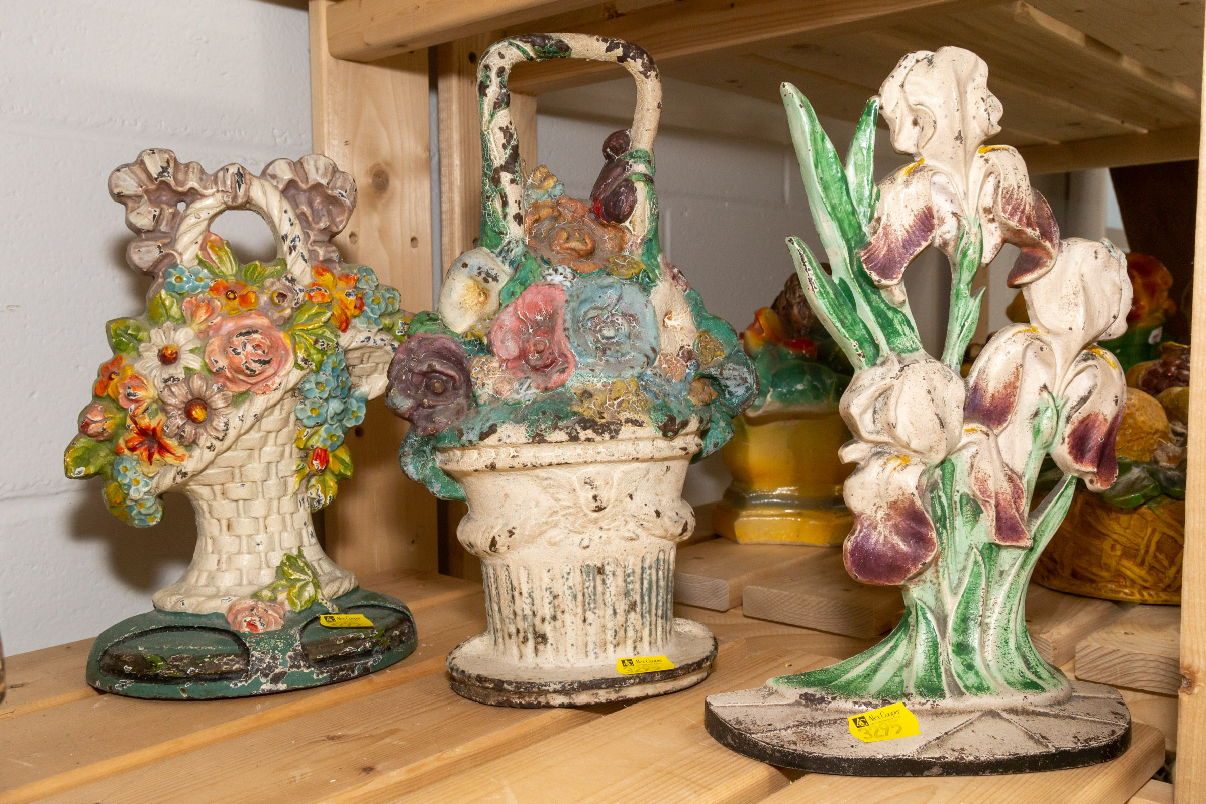 THREE FLORAL CAST IRON DOOR STOPS