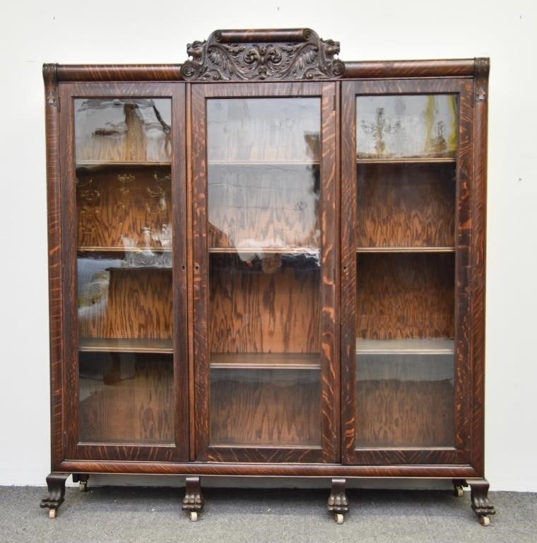 Carved oak three door bookcase,