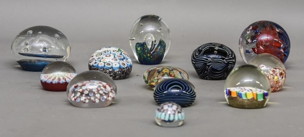 Twelve glass paper weights, largest