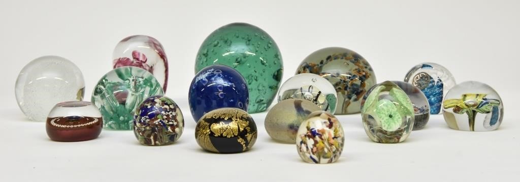 Sixteen glass paperweights including