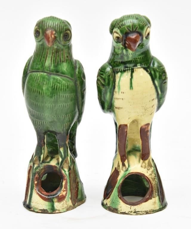 Two similar green glazed parrots, each