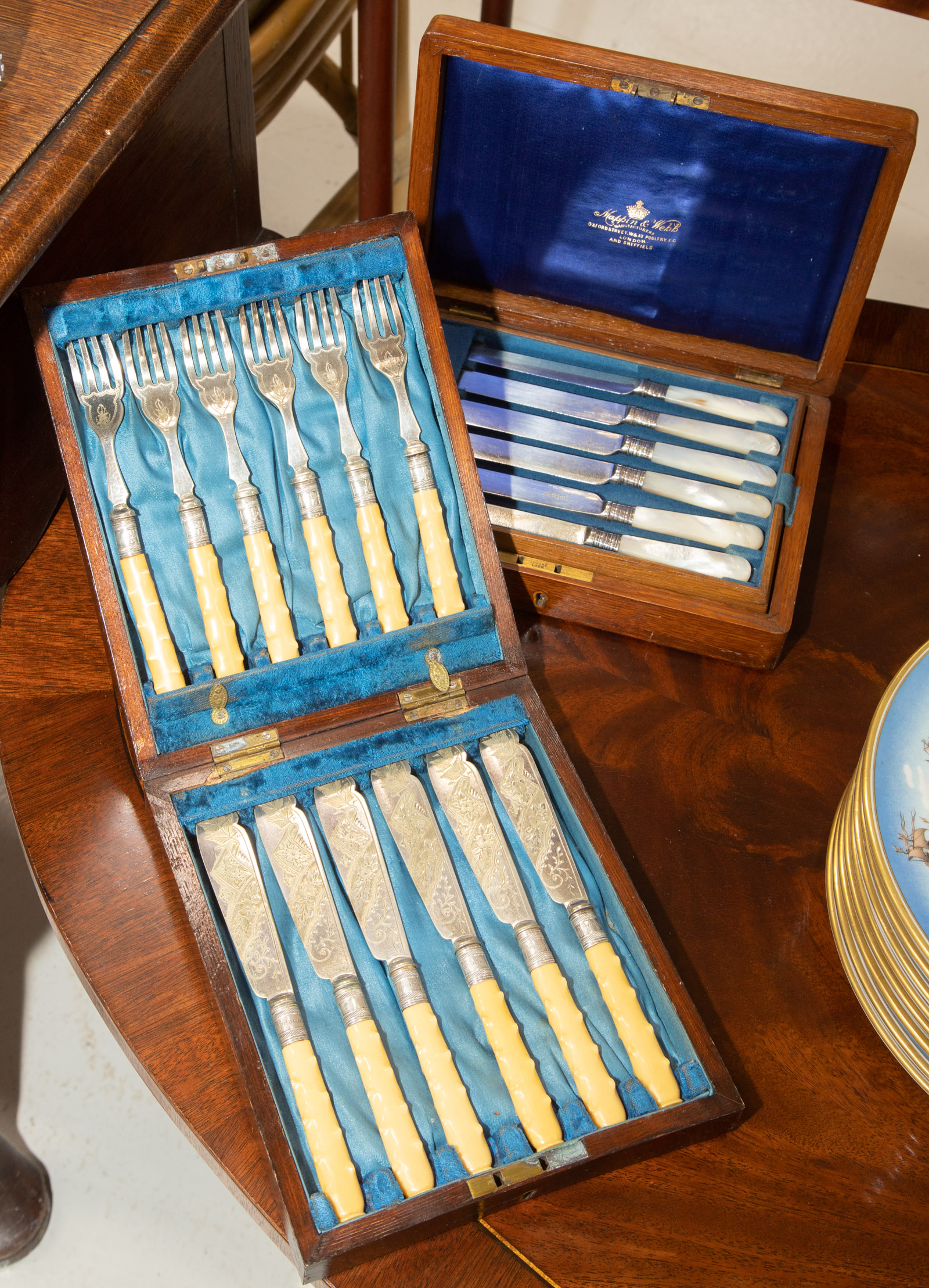 TWO CASED CUTLERY SETS Includes six