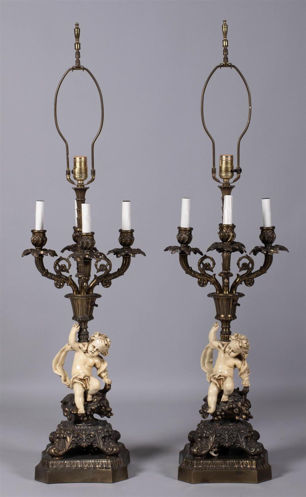 PAIR OF GLAZED POTTERY PUTTO LAMPS
