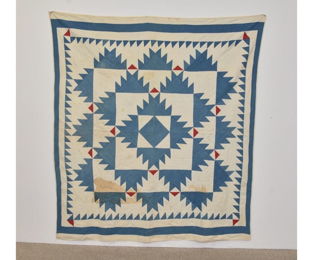 Blue sawtooth pattern appliqué quilt.
80