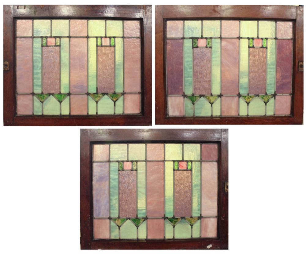 A SET OF THREE STAINED AND LEADED GLASS