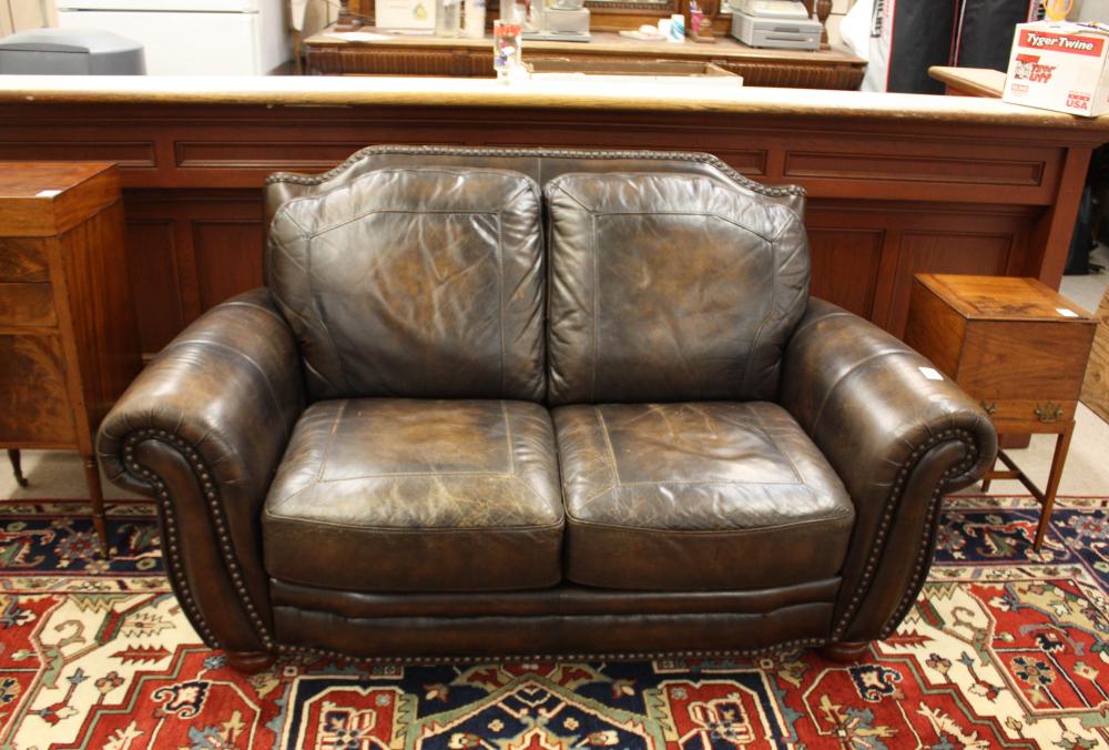 A CONTEMPORARY LEATHER LOVESEAT, DARK