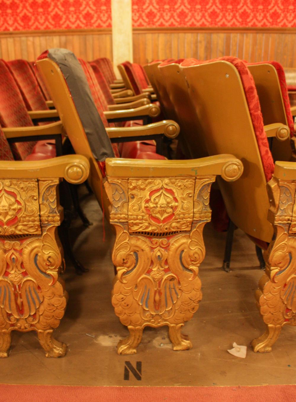 A ROW OF NINE VINTAGE THEATER SEATSA