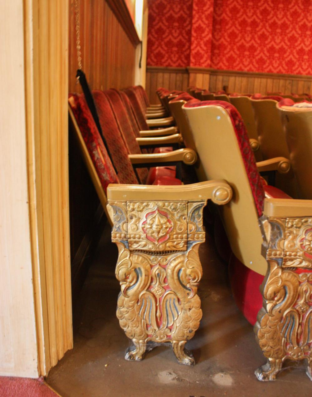 A ROW OF NINE VINTAGE THEATER SEATSA